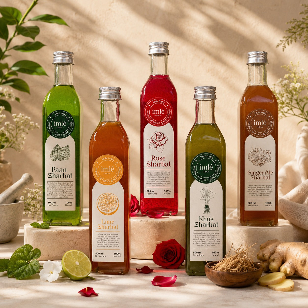 Five bottles of imle Sharbat on a decorative surface with plants and flowers
